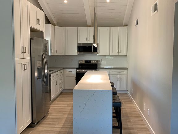Kitchen with vaulted ceilings and large island.
