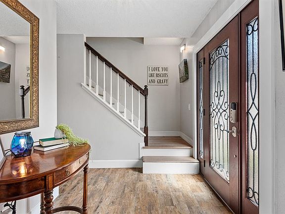 Make an entrance & greet guests in style through your custom wooden front door with in-laid glass & wrought iron detail. Natural light ushers in to highlight a fresh & modern color palate and stunning wood-look ceramic tile spanning across the entire