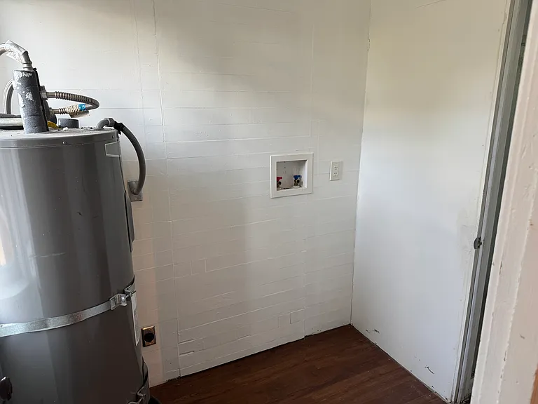 Laundry room with washer and dryer hookups is next to the kitchen and main floor bath.