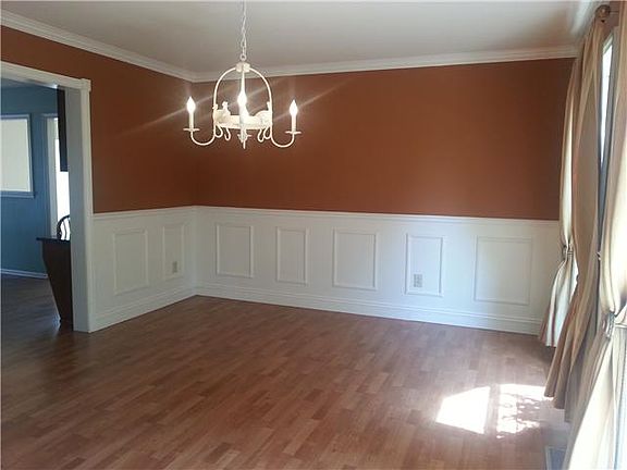 DR w/beautiful wainscoting and crown moulding.