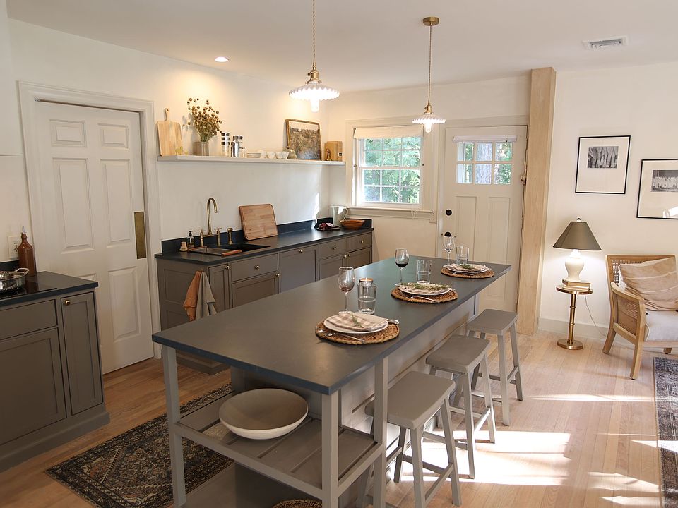 Custom millwork kitchen with huge soapstone island and ceramic lighting.