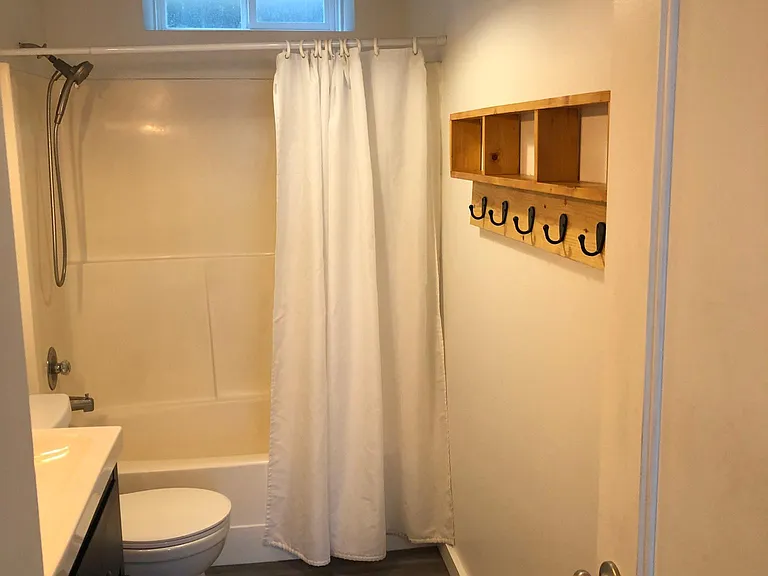full bathroom with two sinks, vinyl flooring
