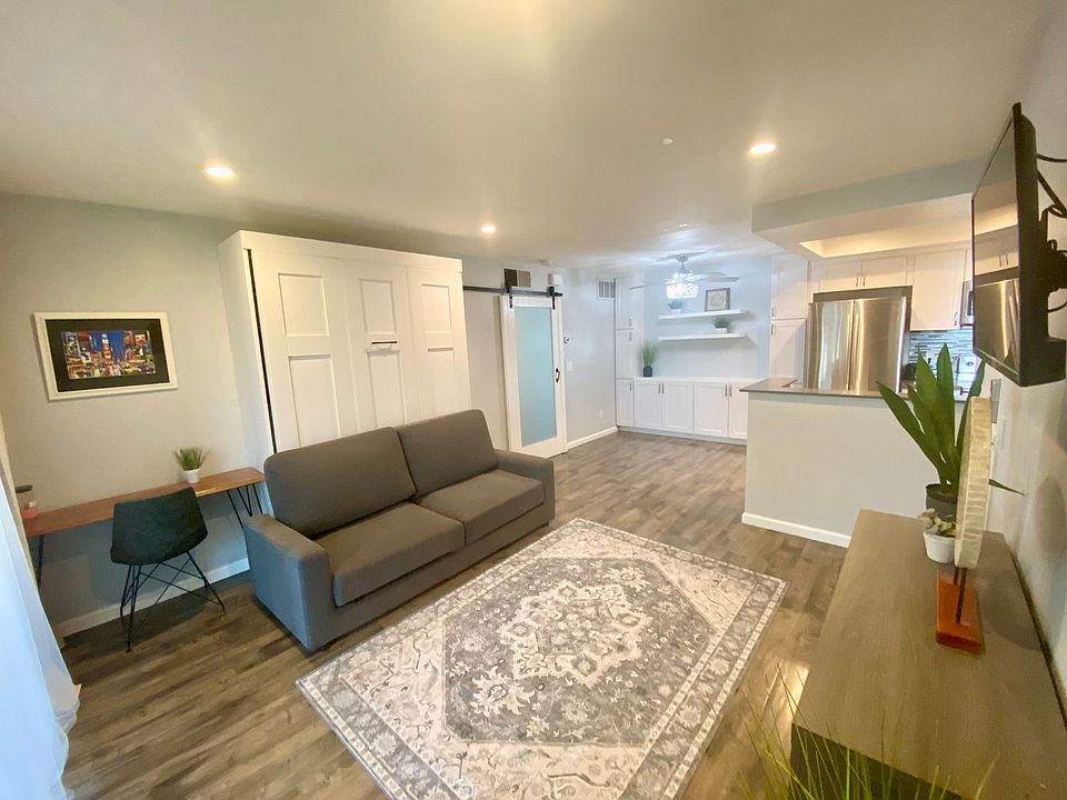 Spacious living room and separate work station outside of the bedroom, next to the window for natural light