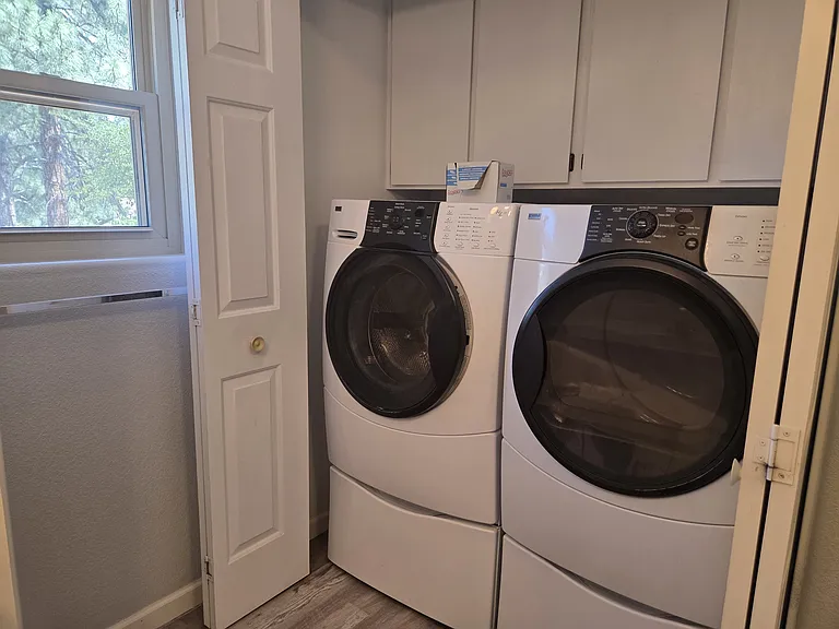Laundry closet situated in the second full size bathroom.