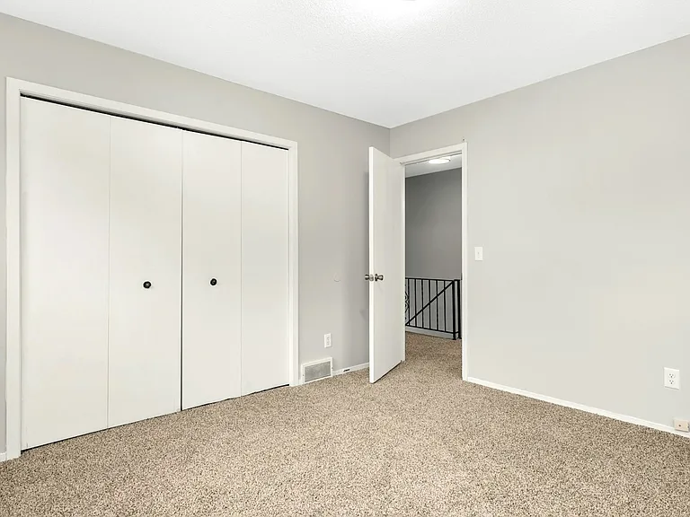 Comfortable primary bedroom with fresh carpet and neutral finishes