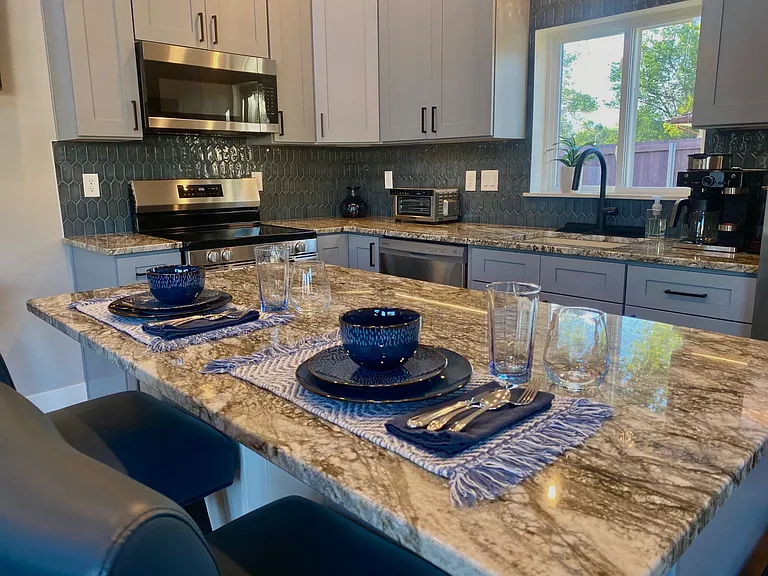 Kitchen is fully stocked with PFAS-free non-stick cookware, bake ware, beautiful dinnerware, glasses, silverware, and anything else you might need for creating a dinner party for six.