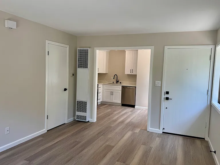 Living room looking towards kitchen and front door