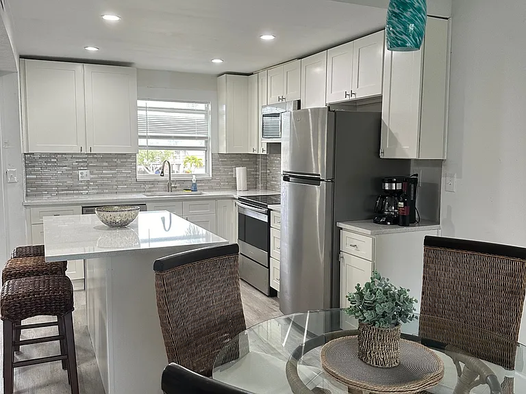 Open concept kitchen with SS appliances, quartz countertops