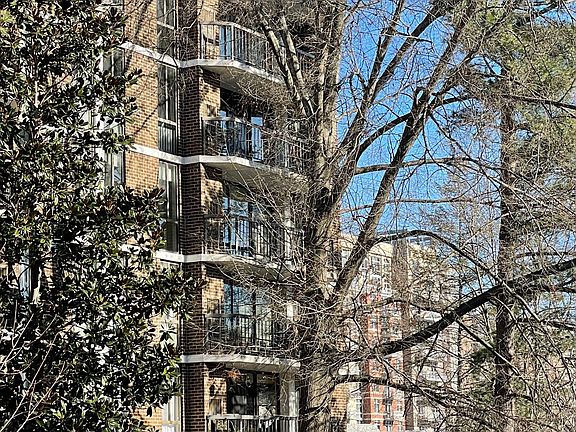 Large balcony with views of tree-lined streets
