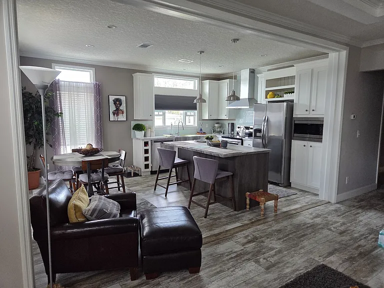 Open concept natural lighting kitchen & dining room with sliding patio door all appliances remain