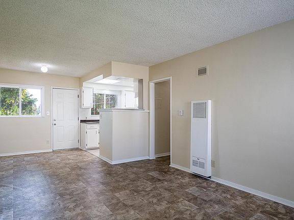 The living room, dining area, and kitchen