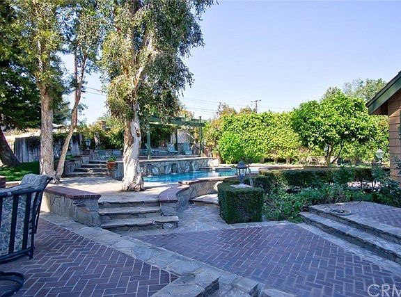 Brick and stone accents this multi-level entertaining backyard!