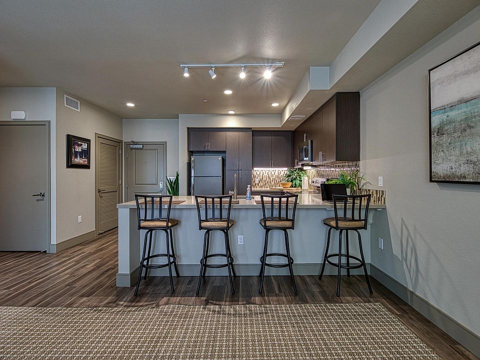 Spacious bar seating opens to an open_concept kitchen, creating an inviting spot for casual dining.