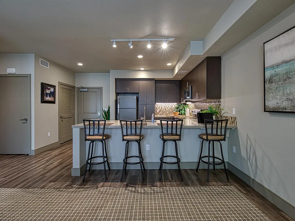 Spacious bar seating opens to an open_concept kitchen, creating an inviting spot for casual dining.