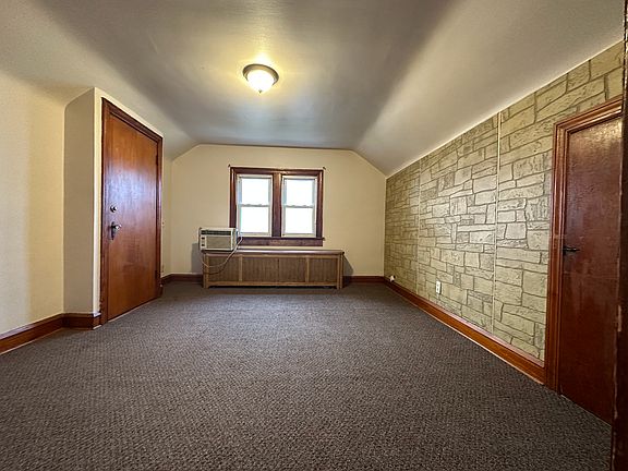Family room with storage on the right and door to the front entrance on the left.