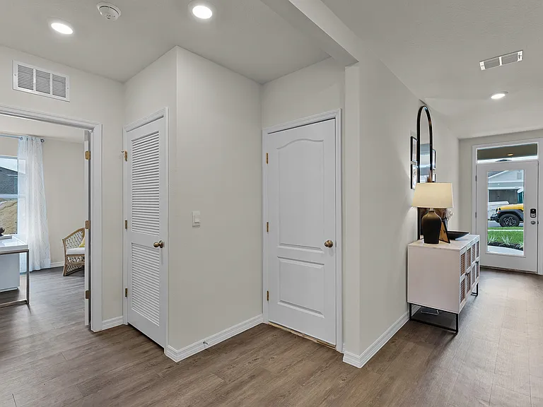 Inviting entryway with wood-style flooring and modern finishes.