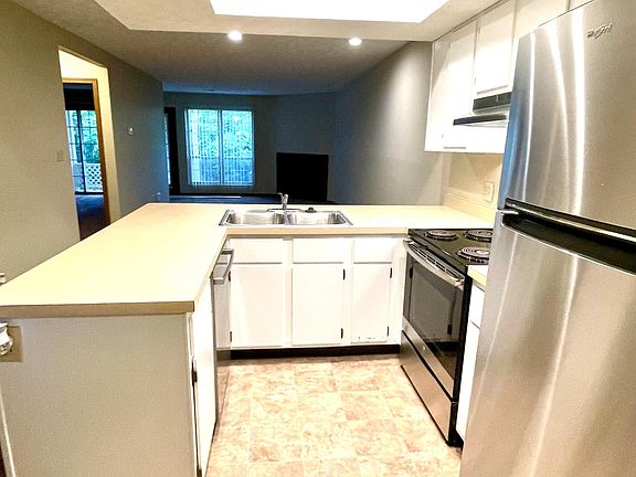 Kitchen with view to living room and patio