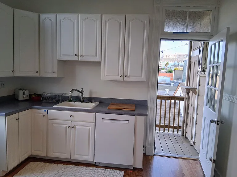 Kitchen door leading to small deck and stairs to backyard.