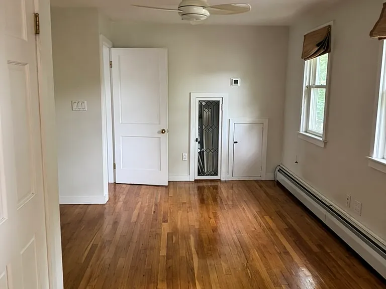 2nd bedroom with fan. Closet is on the left.