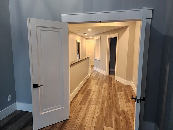 Looking back down the 2nd floor hallway from the main bedroom. There are two bedrooms to the right and the full bathroom at the end of the hall