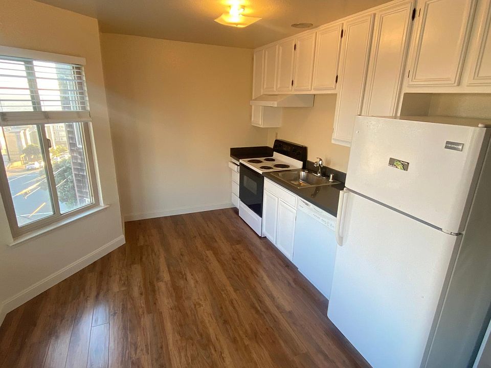 Kitchen with freshly painted cabinets, brand new floors, and updated appliances.