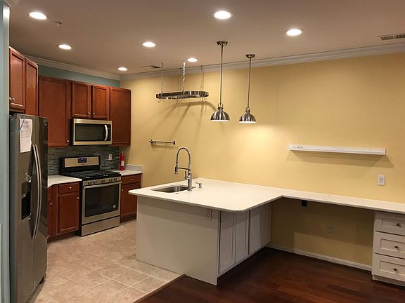 COMPLETELY RENOVATED GOURMET KITCHEN with maple cabinets and LARGE QUARTZ kitchen countertops that can be used for eating area as well as studying/reading/office area. Quartz material is very easy to clean and maintain. PLUS BEAUTIFUL MODERN BACKSPLASH, N