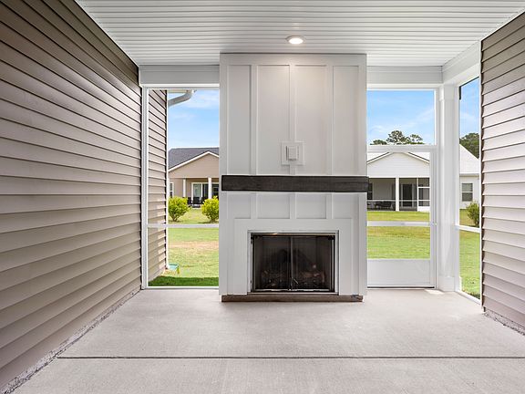Enjoy year-round relaxation on the covered patio featuring a built-in fireplace, perfect for outdoor