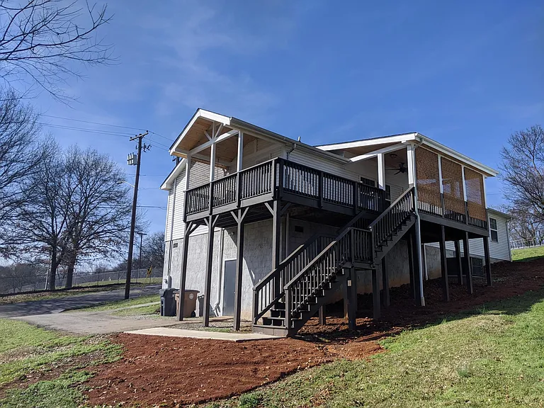 The back and the side covered decks ready with porch swing, ceiling fan, lights and outlets
