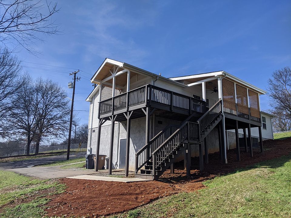 The back and the side covered decks ready with porch swing, ceiling fan, lights and outlets