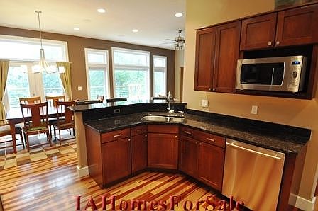 The view from the kitchen overlooks the deck, dining area and living room.