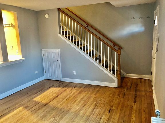 Living Room Area w/ Storage Area Under Stairs