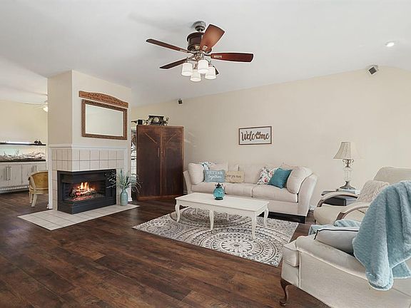 Your expansive living room is divided dramatically by a gas log fireplace that adds a cozy touch to your homes relaxing and entertaining areas.