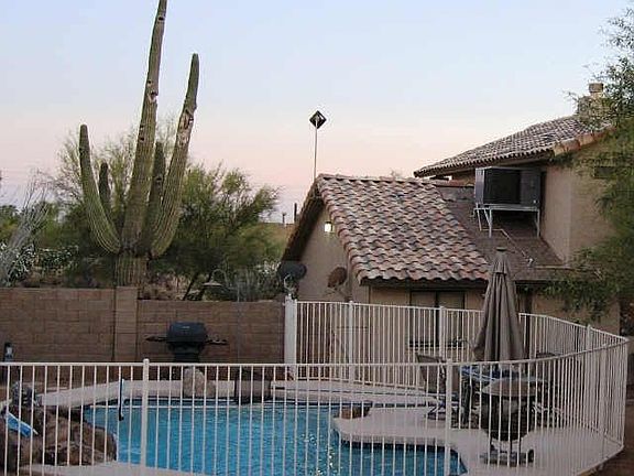 Backyard resort pool with waterfall