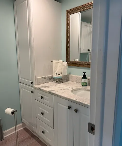 Primary bath. Marble counter. Lots of cabinets.