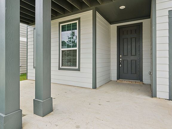 This front porch would be so cute with a few chairs and a plant. Perfect for morning coffee!