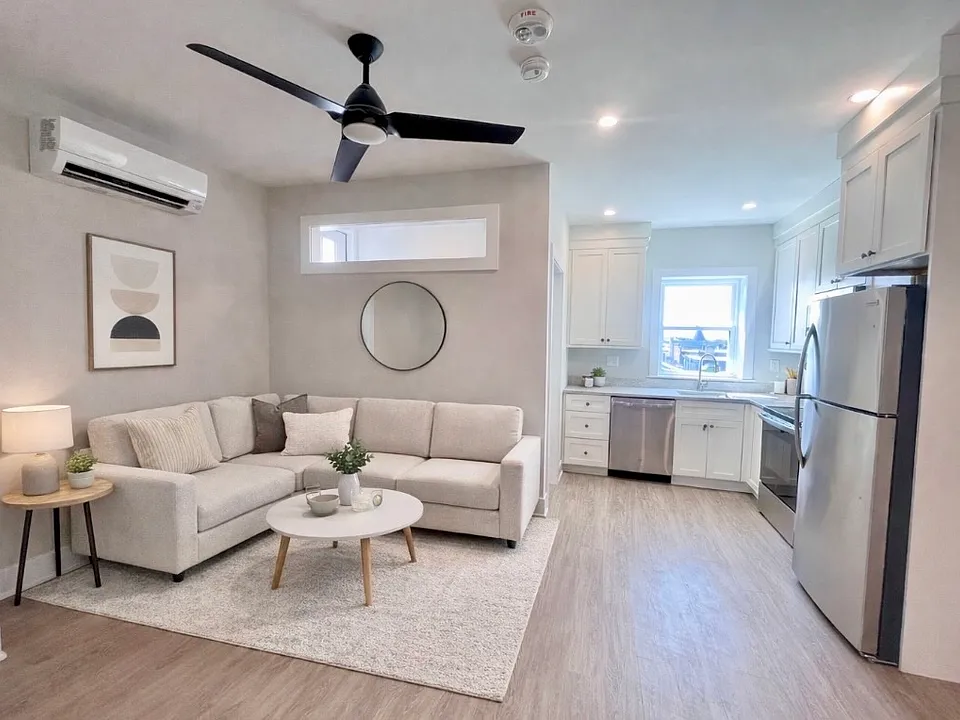 Open concept living room and kitchen (virtually staged)