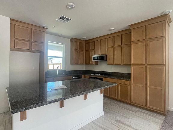 Kitchen with upgraded cabinets, lots of storage! Quartz counters, Gas stove top with griddle.