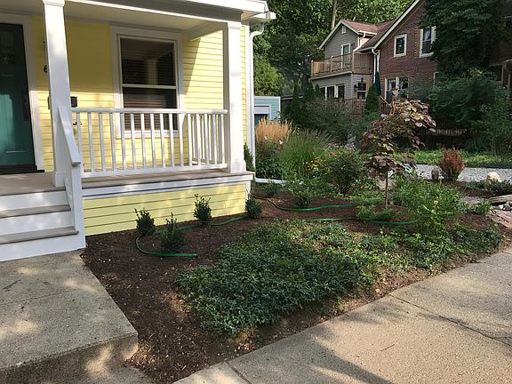 Front porch view, with detached garage office visible in back.