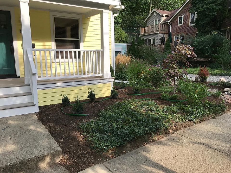 Front porch view, with detached garage office visible in back.