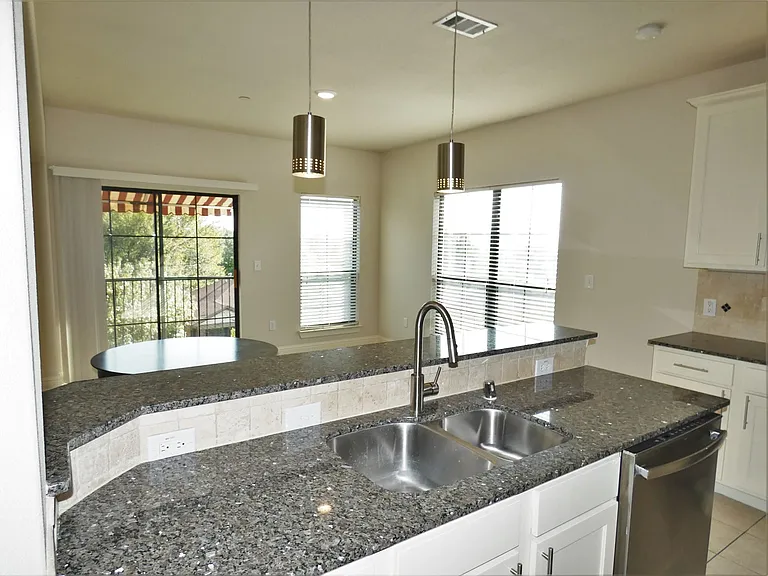 Beautiful granite counter in Kitchen with freshly painted white cabinets! Open to DR and LR!