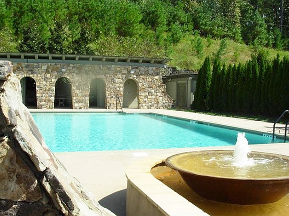 A large gorgeous pool with bathrooms, fountain, and semi-pri