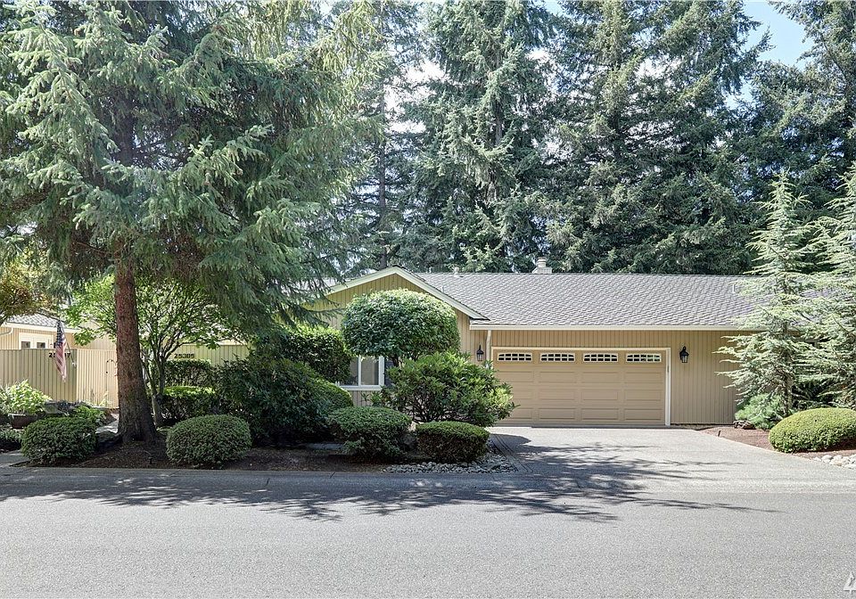 Front of condo with a two car garage.