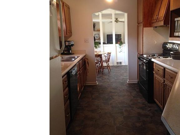 Kitchen is updated with appliances, oak cabinets & flooring