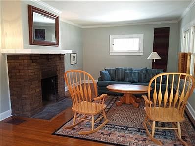 Spacious living room has wood-burning fireplace to keep it cozy and plenty of room for the whole family.