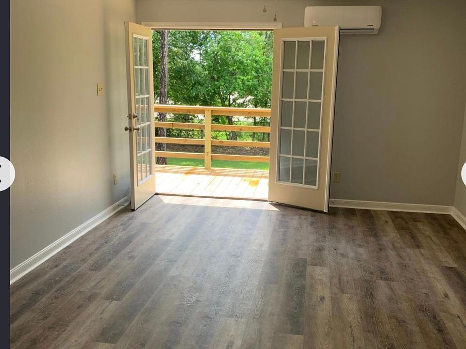 Open concept living room kitchen overlooks private backyard