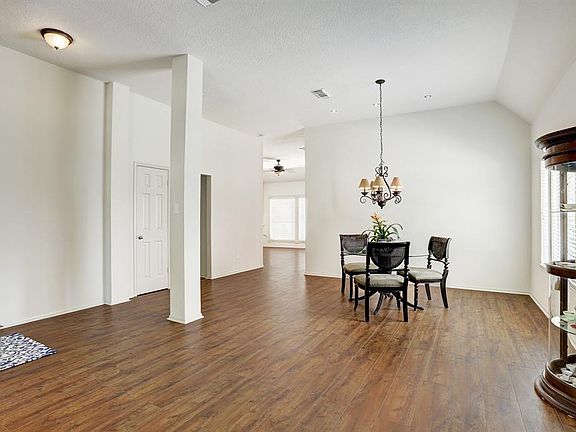 A peek into the Family Room from the formal Dining Room - high ceilings with solid floors lend to the functional flow of the home.