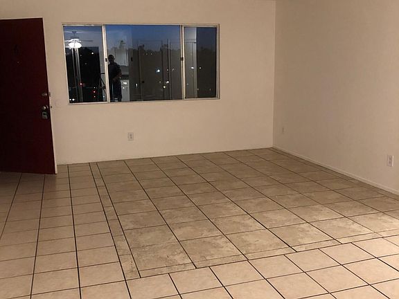 View from dining room towards living room and front door. All tile floor throughout.