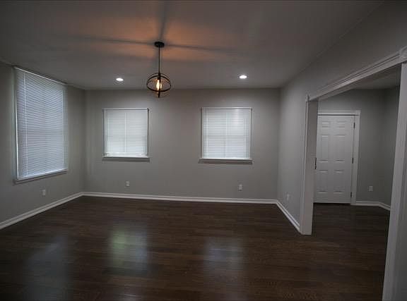 Family room with high ceilings. Laminate flooring throughout.