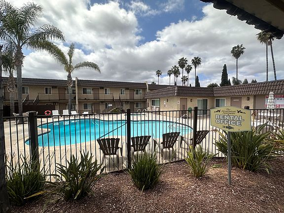 Swimming pool and palm trees at The Meadowlark Apartments in San Marcos.