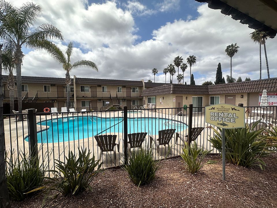 Swimming pool and palm trees at The Meadowlark Apartments in San Marcos.